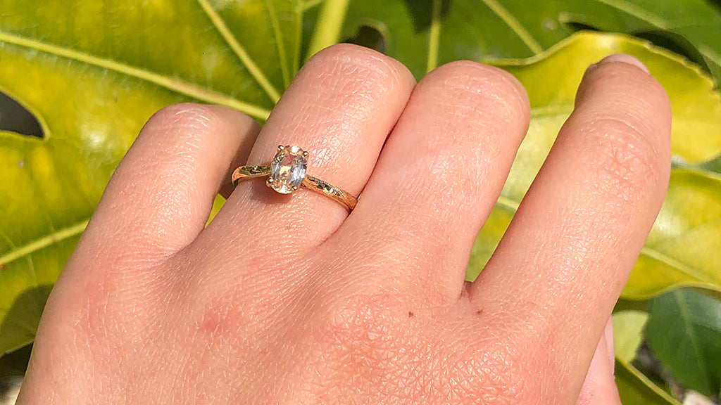 yellow gold engagement ring on finger